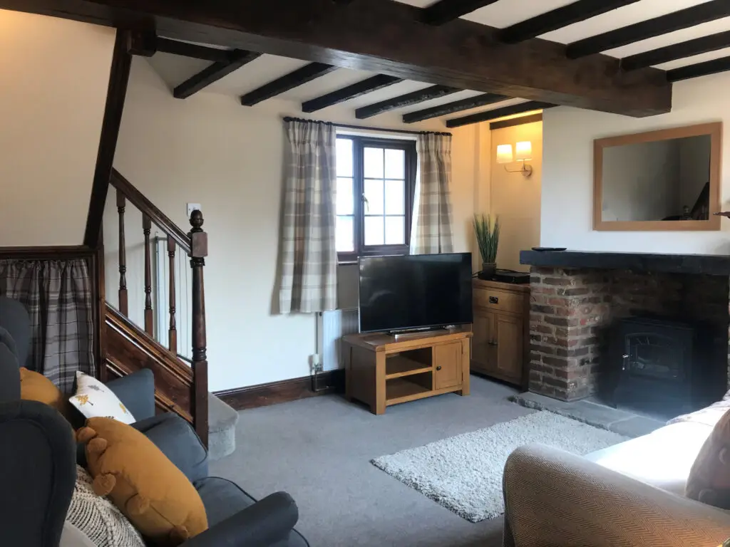 Dovedale Cottage oak-beamed living room at Callow Top Holiday Park